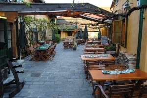 Typical dining setting at the vintner's bush tavern (Heuriger) Mayer am Pfarrplatz in Vienna. Beethoven lived for a while in the building on the left.