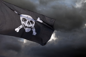 The Jolly Roger, one of the traditional pirate flags, against storm clouds